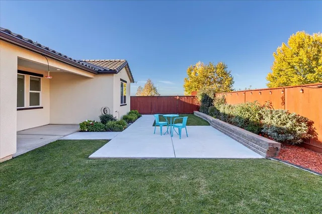 a front view of a house with a yard table and chairs