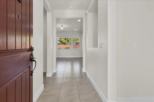 a view of a hallway with wooden shelves