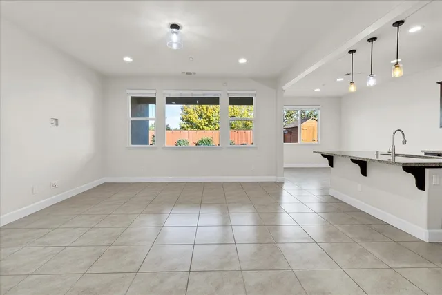 an empty room with white walls and windows