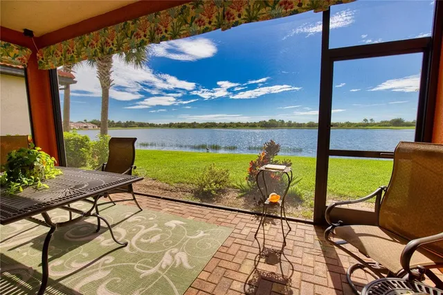 a living room with furniture a flat screen tv and a large window