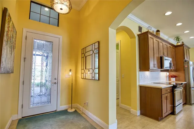 a kitchen with a refrigerator and a stove top oven