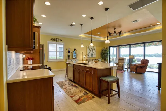 a large kitchen with a large window and stainless steel appliances