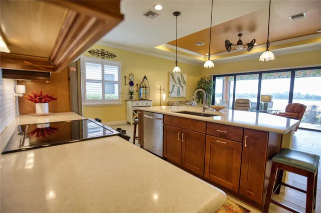 a kitchen with stainless steel appliances granite countertop a sink refrigerator and cabinets