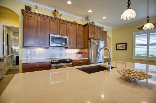 a kitchen with granite countertop a stove and cabinets
