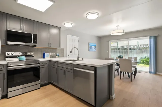 a kitchen with a sink stove and microwave