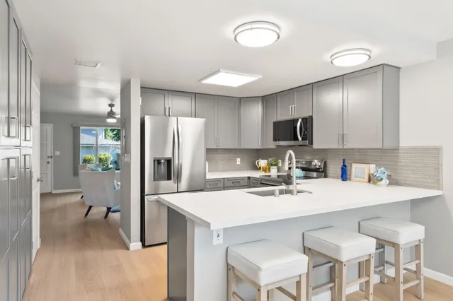 a kitchen with a sink cabinets and refrigerator
