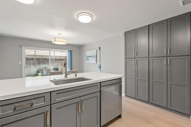 a kitchen with a sink and large window