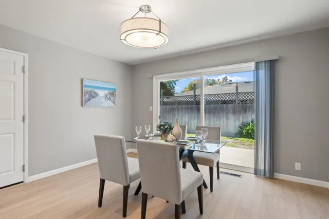a dining room with furniture a window and wooden floor