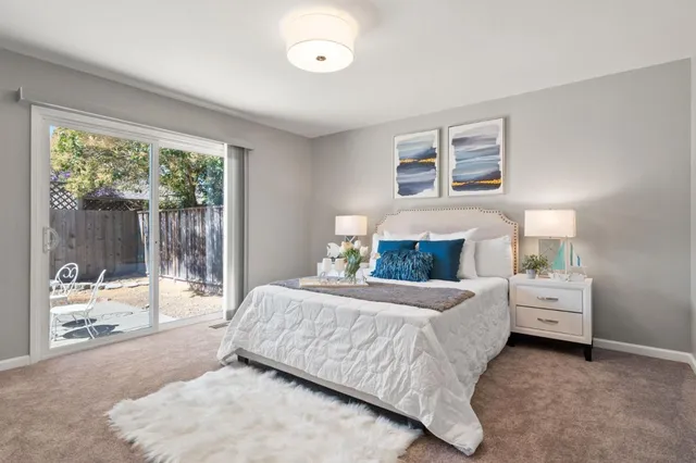 a bedroom with a bed and large window