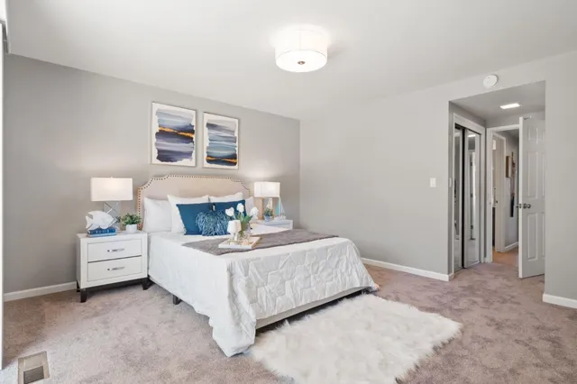 a bedroom with a bed and a lamp