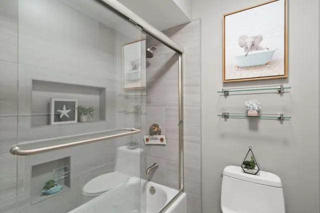 a bathroom with a toilet a sink and bathtub