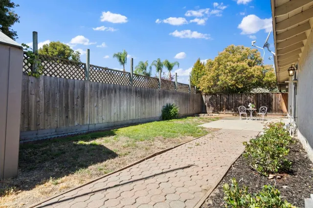 a view of a backyard with pathway
