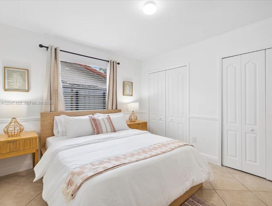 9840 Southwest 3rd Street Miami, FL 33174 - Photo 21 of 25 a bedroom with a bed and a window