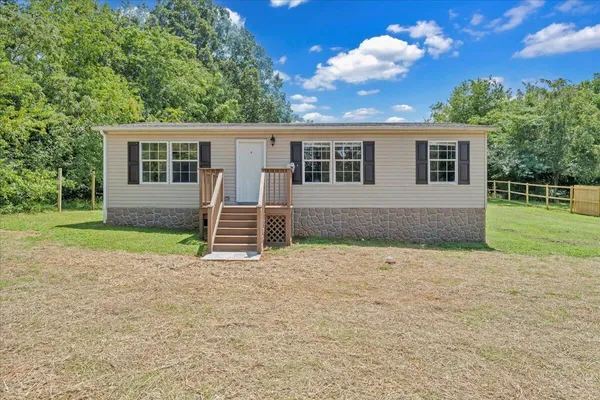 a backyard of a house with barbeque oven