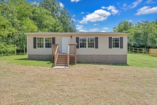 a backyard of a house with barbeque oven