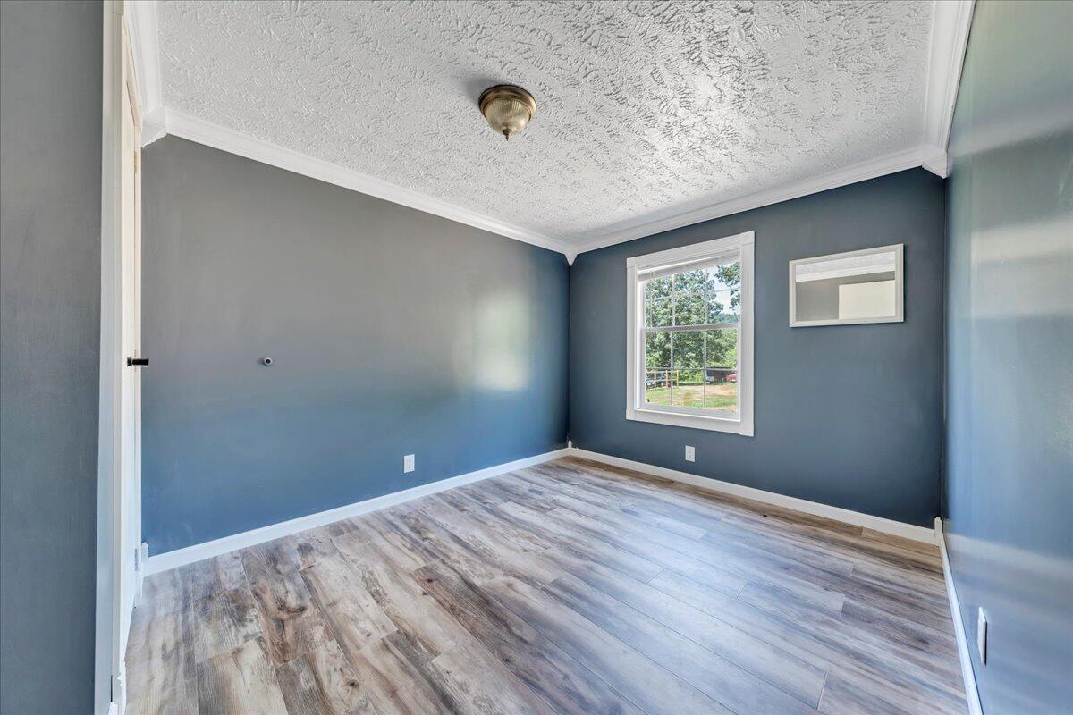 6638 Stewartsville Road Moneta, VA 24121 - Photo 11 of 27 a view of empty room with window and wooden floor