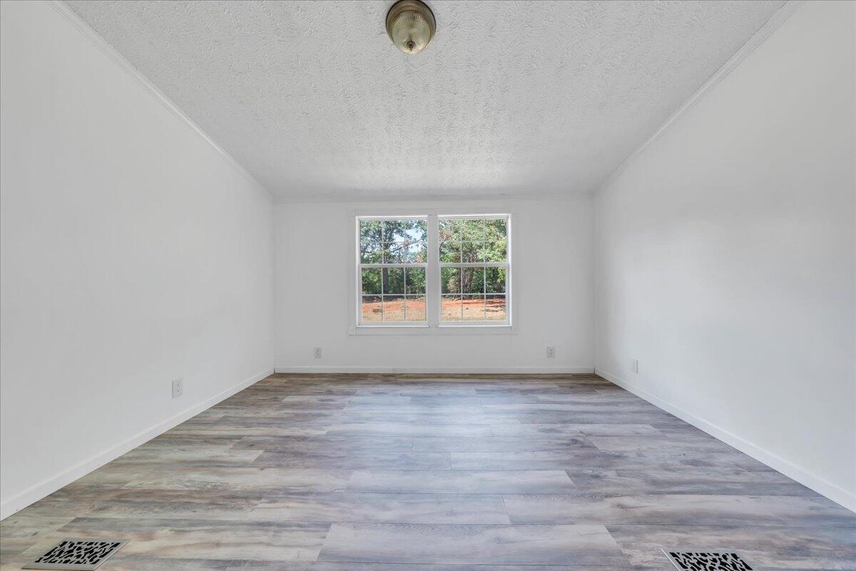 6638 Stewartsville Road Moneta, VA 24121 - Photo 14 of 27 an empty room with wooden floor and windows