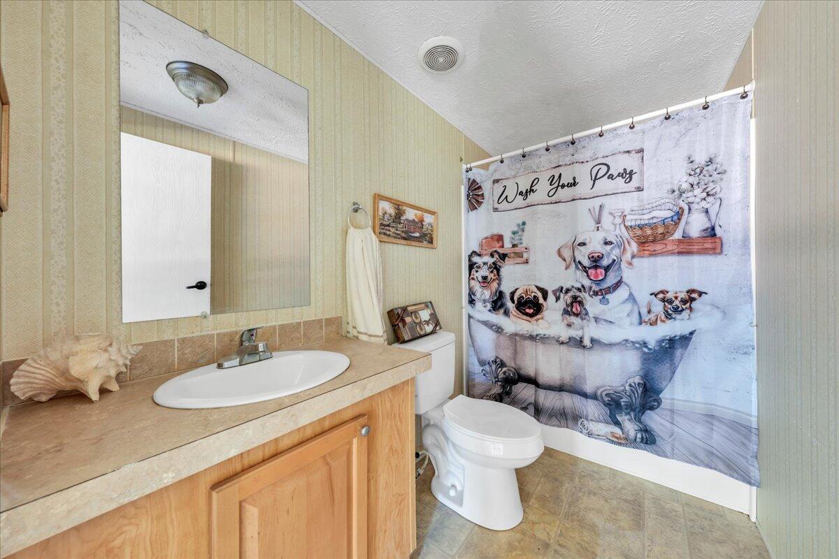 6638 Stewartsville Road Moneta, VA 24121 - Photo 19 of 27 a bathroom with a granite countertop sink mirror vanity and toilet