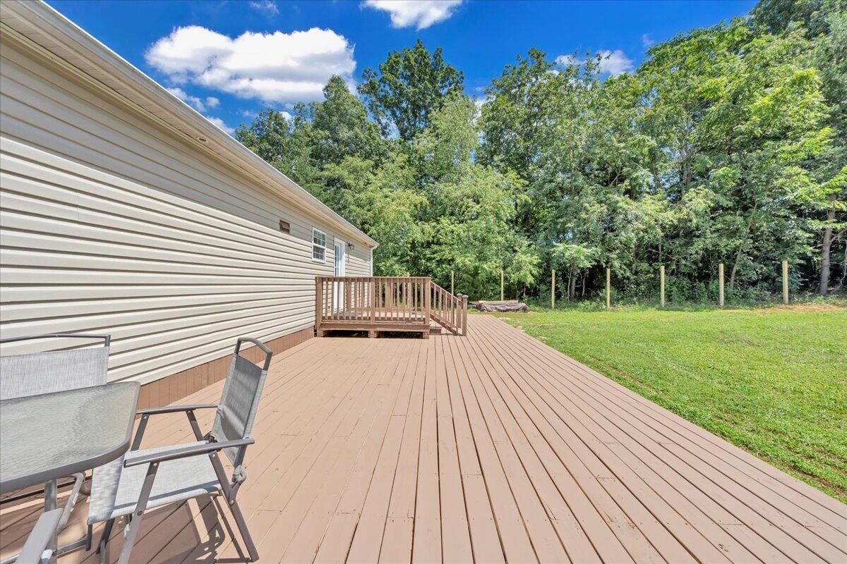 6638 Stewartsville Road Moneta, VA 24121 - Photo 24 of 27 a view of a house with backyard and a sitting area