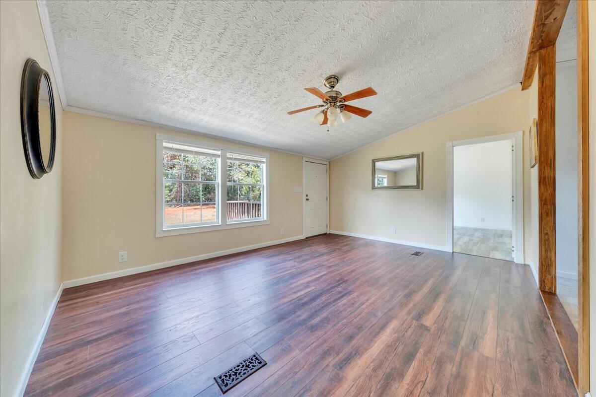 6638 Stewartsville Road Moneta, VA 24121 - Photo 2 of 27 a view of empty room with wooden floor and fan