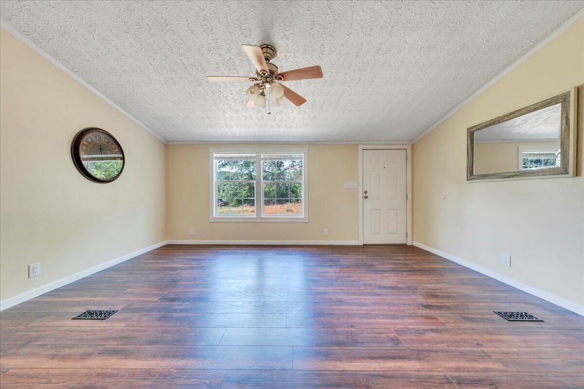 6638 Stewartsville Road Moneta, VA 24121 - Photo 3 of 27 an empty room with a window and a ceiling fan