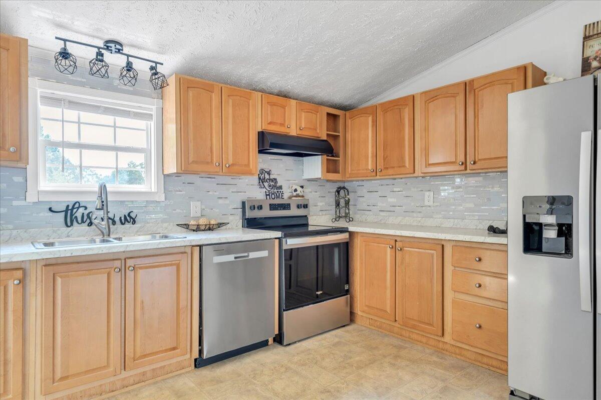 6638 Stewartsville Road Moneta, VA 24121 - Photo 5 of 27 a kitchen with granite countertop a sink stainless steel appliances and cabinets