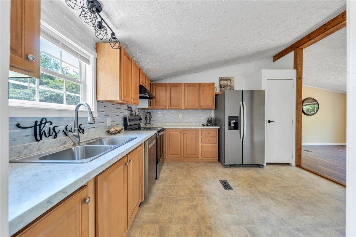 6638 Stewartsville Road Moneta, VA 24121 - Photo 7 of 27 a kitchen with stainless steel appliances granite countertop a refrigerator and a sink