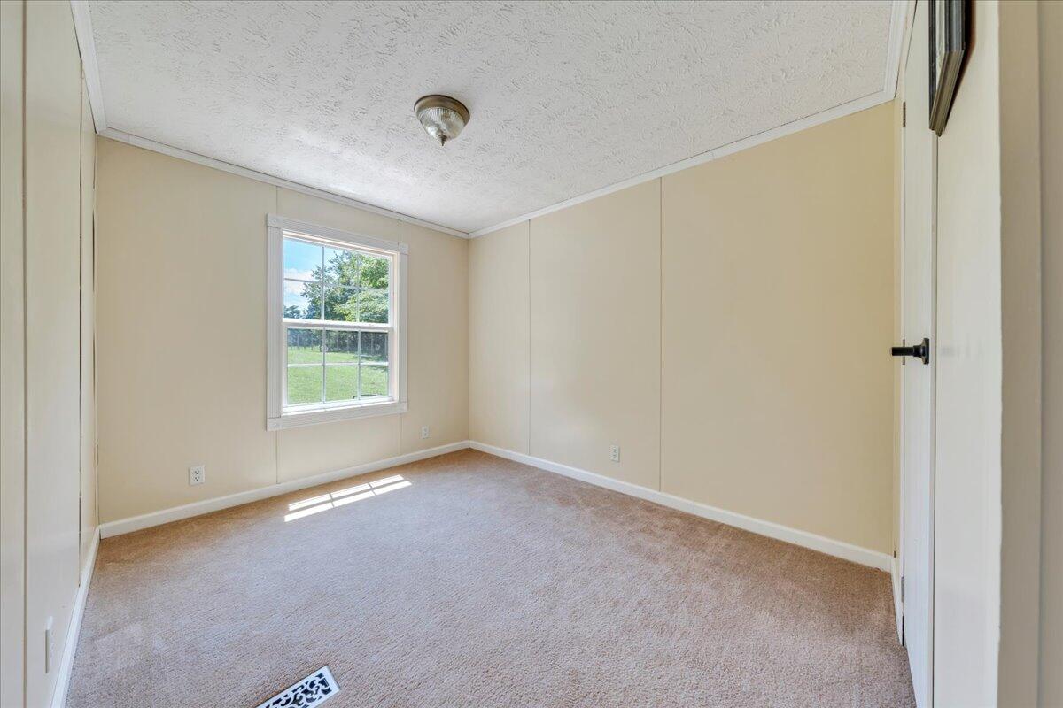 6638 Stewartsville Road Moneta, VA 24121 - Photo 9 of 27 an empty room with windows