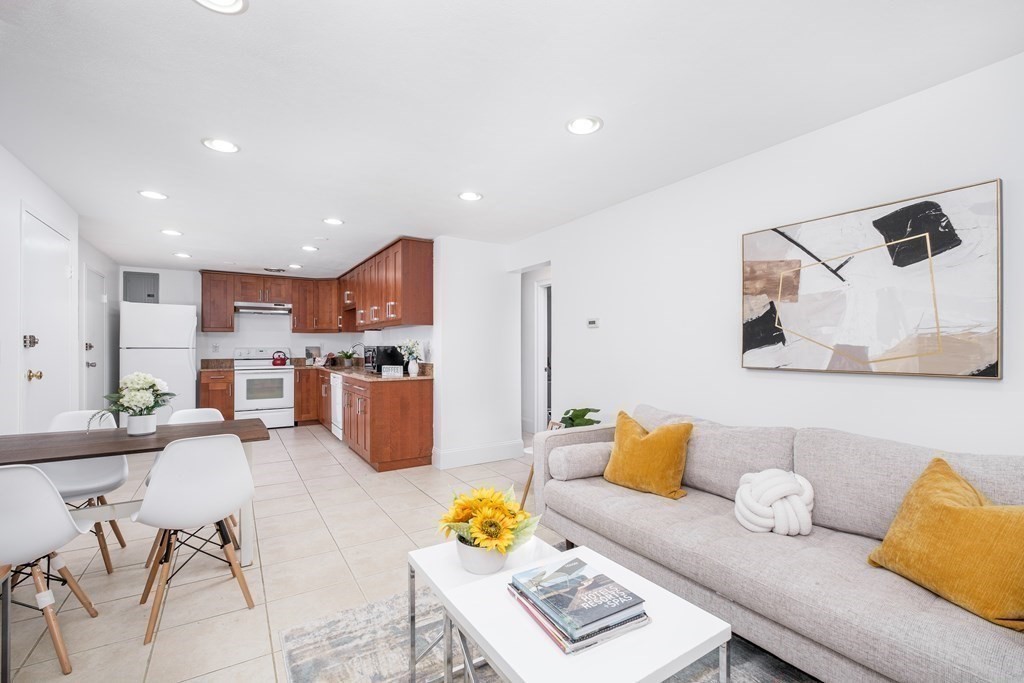 a living room with furniture kitchen view and a table