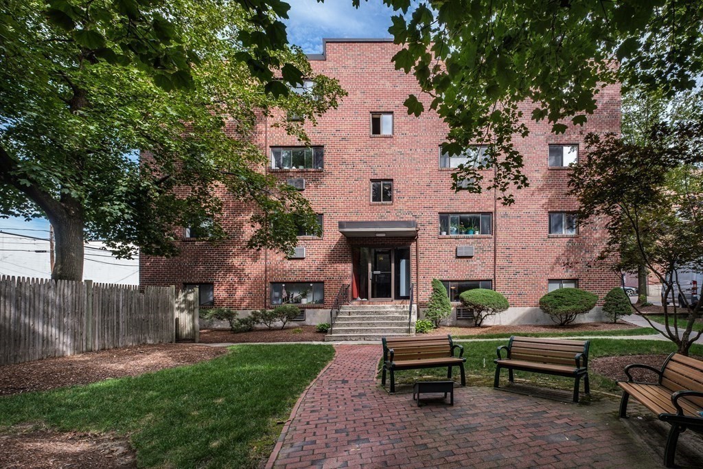 14 Riverside Street, Unit G3 Watertown, MA 02472 - Photo 14 of 18 a view of a house with patio a backyard