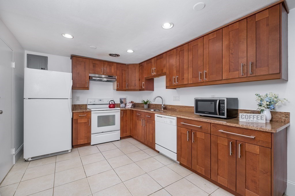 14 Riverside Street, Unit G3 Watertown, MA 02472 - Photo 2 of 18 a kitchen with granite countertop appliances a sink and cabinets