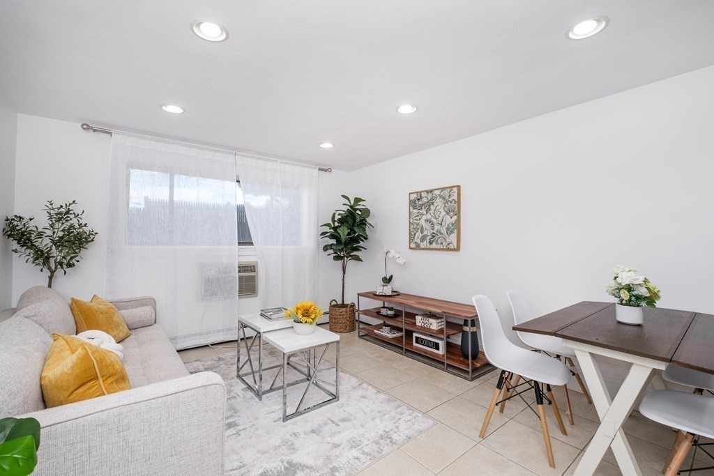 14 Riverside Street, Unit G3 Watertown, MA 02472 - Photo 4 of 18 a living room with furniture and wooden floor