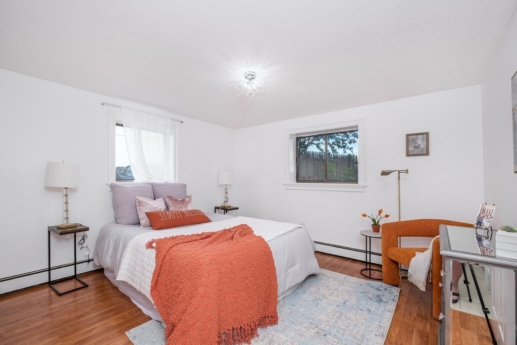 14 Riverside Street, Unit G3 Watertown, MA 02472 - Photo 5 of 18 a bedroom with a bed a desk and chair