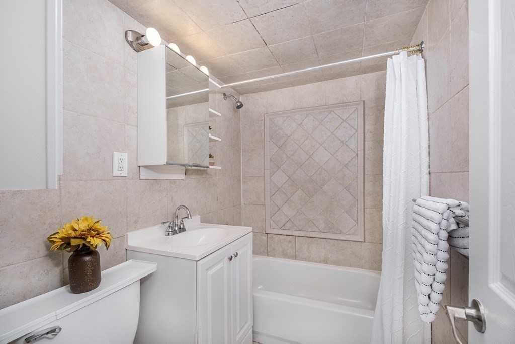 14 Riverside Street, Unit G3 Watertown, MA 02472 - Photo 9 of 18 a bathroom with a sink a toilet and shower