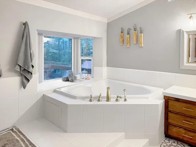 a bath tub sitting in a bathroom next to a window