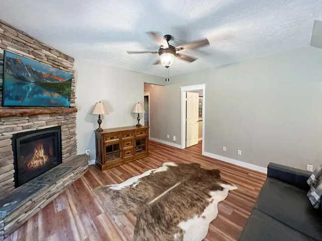 a living room with furniture and a fireplace