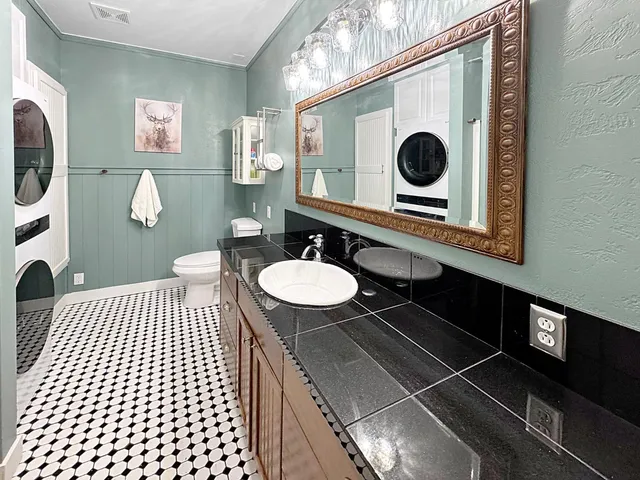 a close view of a utility room with dryer and washer