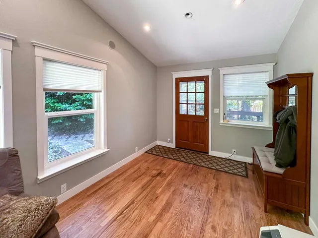a view of an empty room with a window and workspace