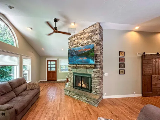 a living room with furniture a window and a fireplace