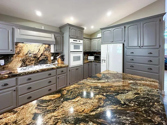 a kitchen with refrigerator and window