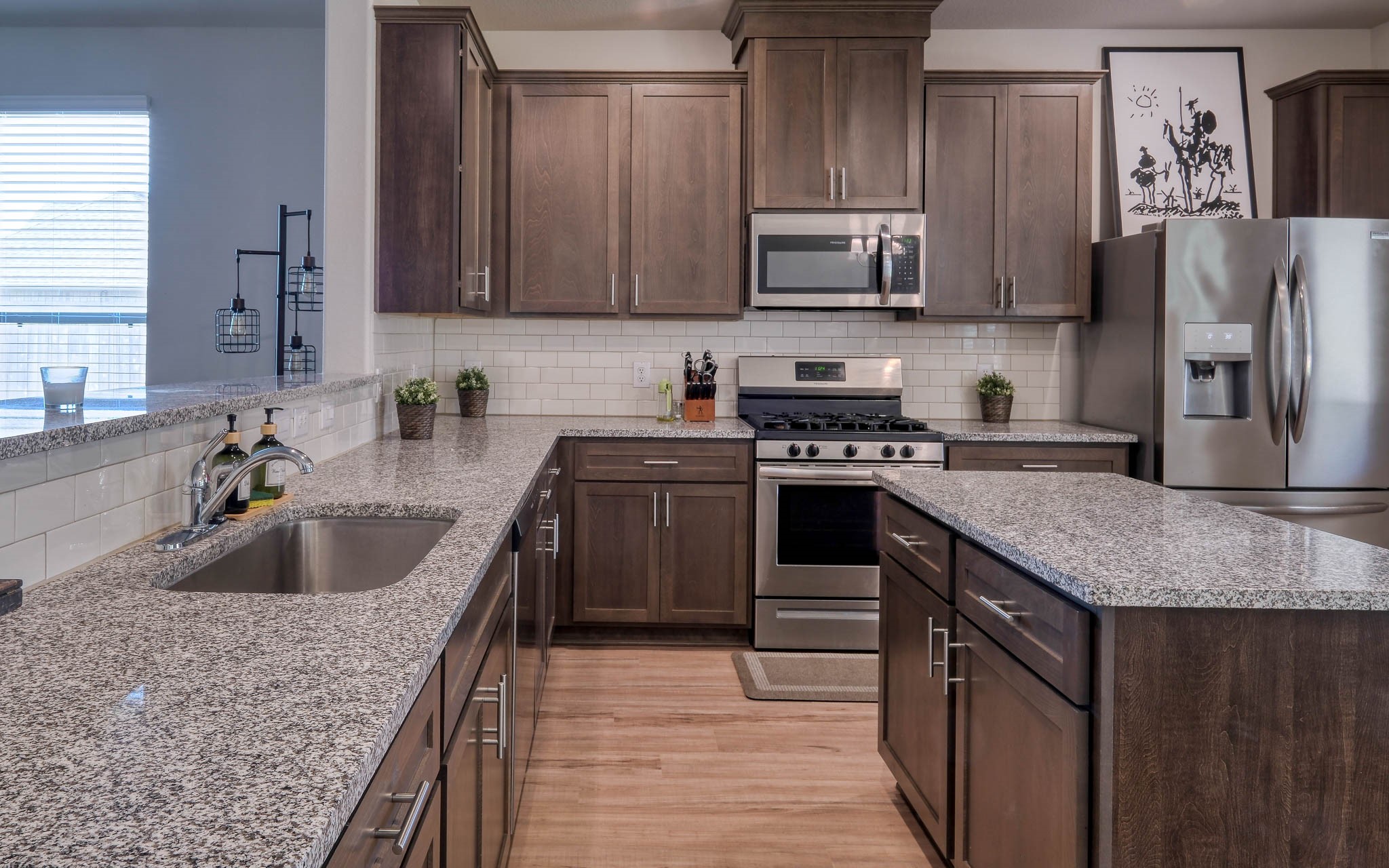 16747 Rockwall Street Conroe, TX 77303 - Photo 15 of 50 a kitchen with stainless steel appliances granite countertop a sink stove and refrigerator