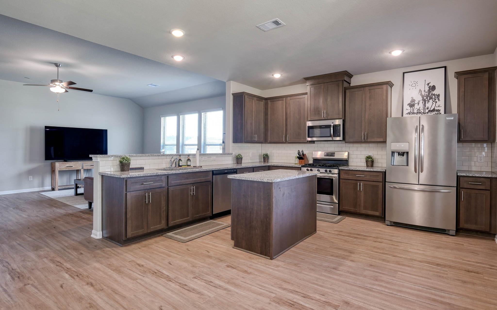 16747 Rockwall Street Conroe, TX 77303 - Photo 17 of 50 Open Concept Living. Refrigerator is negotiable. Front to back, this .99 acre has so many possibilities and awaits your imagination. 16747 Rockwall St, 77303 features .9 partially cleared acre, stone and brick home built in 2023. Well cared for, and ready to grow your dreams!