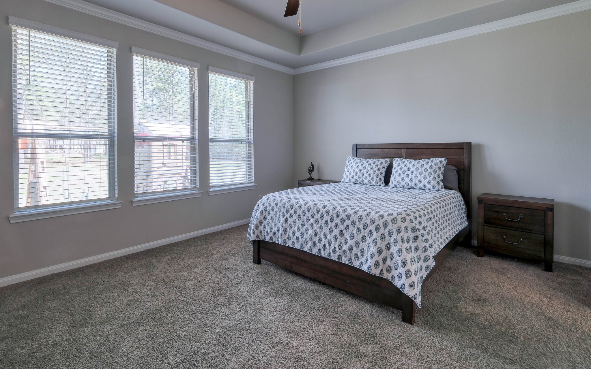 16747 Rockwall Street Conroe, TX 77303 - Photo 24 of 50 Sweet dreams in this clean and airy Primary suite with large ensuite bath. Front to back, this .99 acre has so many possibilities and awaits your imagination. 16747 Rockwall St, 77303 features .9 partially cleared acre, stone and brick home built in 2023. Well cared for, and ready to grow your dreams!