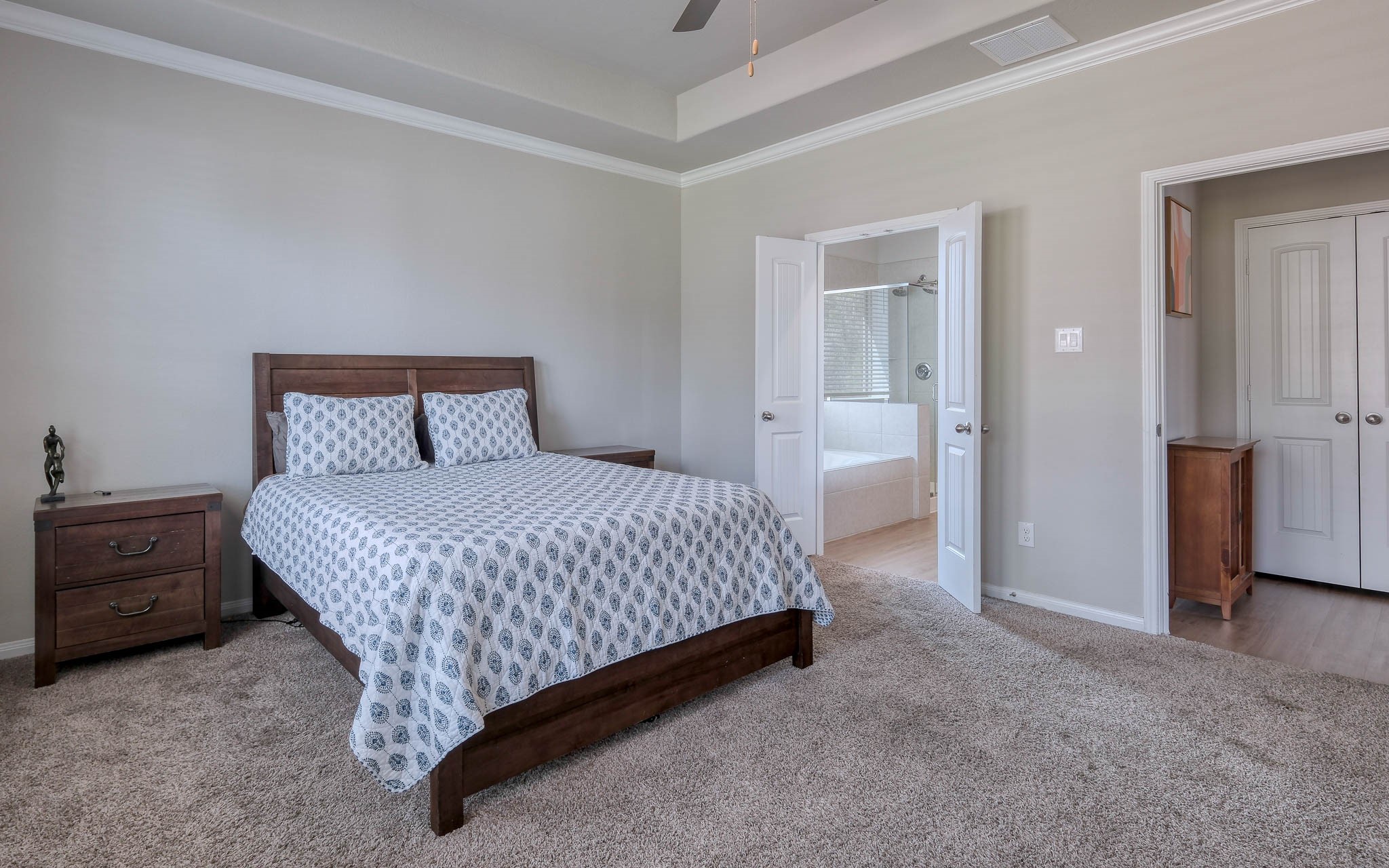 16747 Rockwall Street Conroe, TX 77303 - Photo 25 of 50 a spacious bedroom with a bed and a cabinets