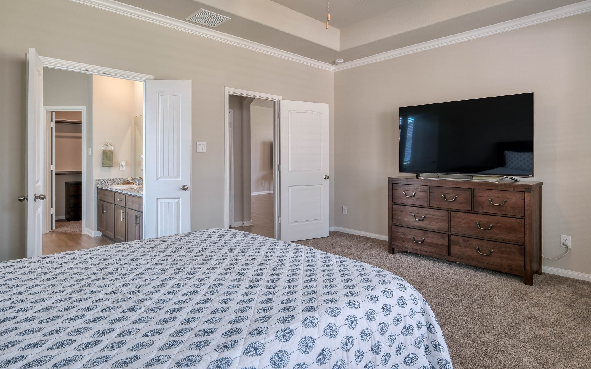 16747 Rockwall Street Conroe, TX 77303 - Photo 26 of 50 a bedroom with a bed and a flat screen tv in it