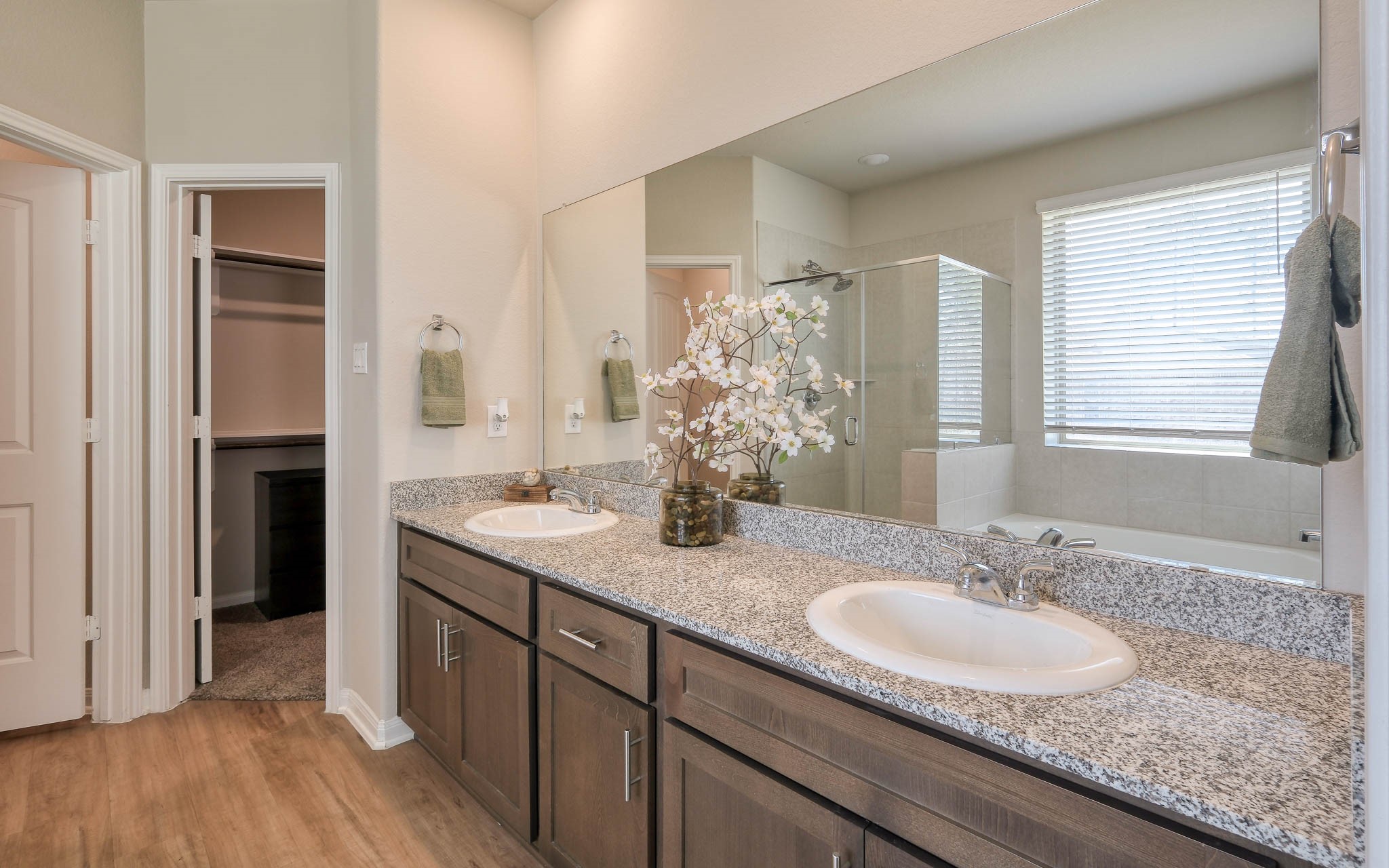 16747 Rockwall Street Conroe, TX 77303 - Photo 29 of 50 a bathroom with a granite countertop sink a large mirror and a shower