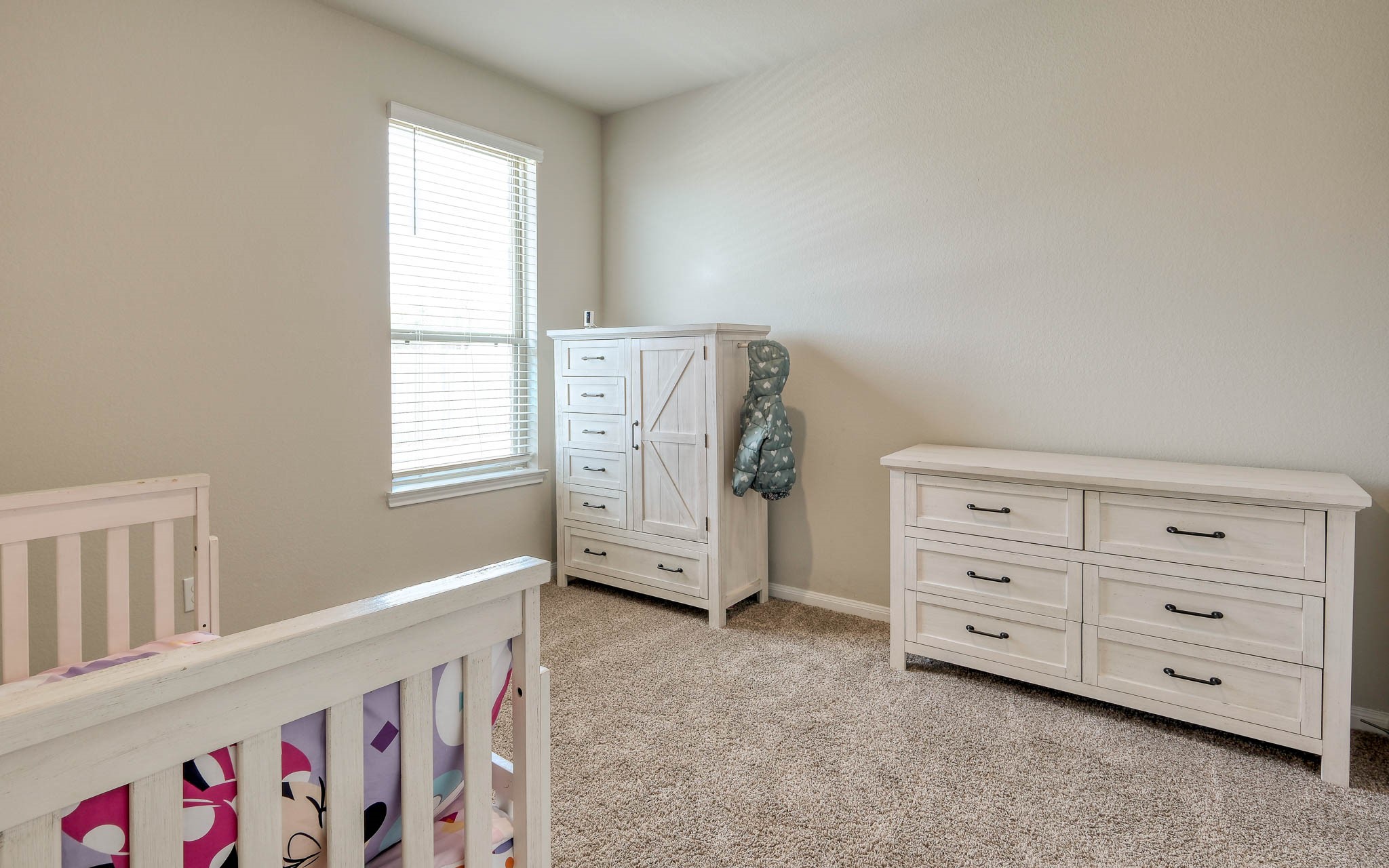 16747 Rockwall Street Conroe, TX 77303 - Photo 30 of 50 Secondary Bedroom is bright and clean with roomy closet space. Front to back, this .99 acre has so many possibilities and awaits your imagination. 16747 Rockwall St, 77303 features .9 partially cleared acre, stone and brick home built in 2023. Well cared for, and ready to grow your dreams!