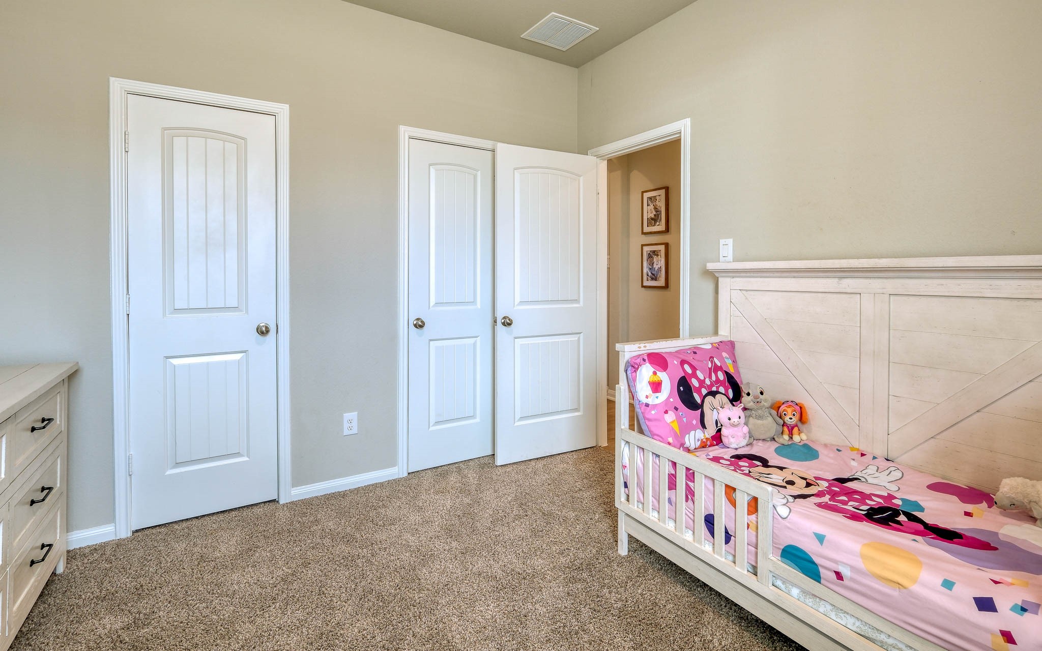 16747 Rockwall Street Conroe, TX 77303 - Photo 31 of 50 a bedroom with a bed and a dresser in it