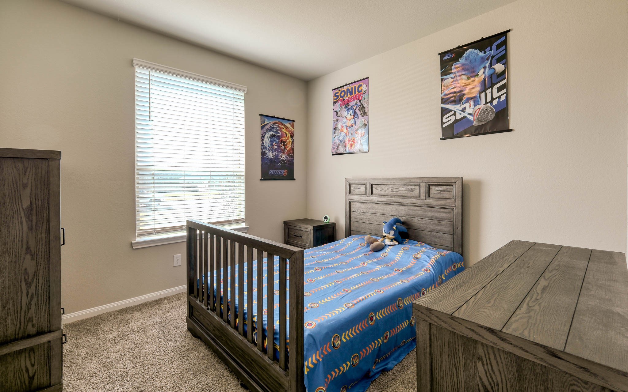 16747 Rockwall Street Conroe, TX 77303 - Photo 32 of 50 Bedroom 4 is situated at the front of the home. Restful wall tones and a roomy closet. Front to back, this .99 acre has so many possibilities and awaits your imagination. 16747 Rockwall St, 77303 features .9 partially cleared acre, stone and brick home built in 2023. Well cared for, and ready to grow your dreams!