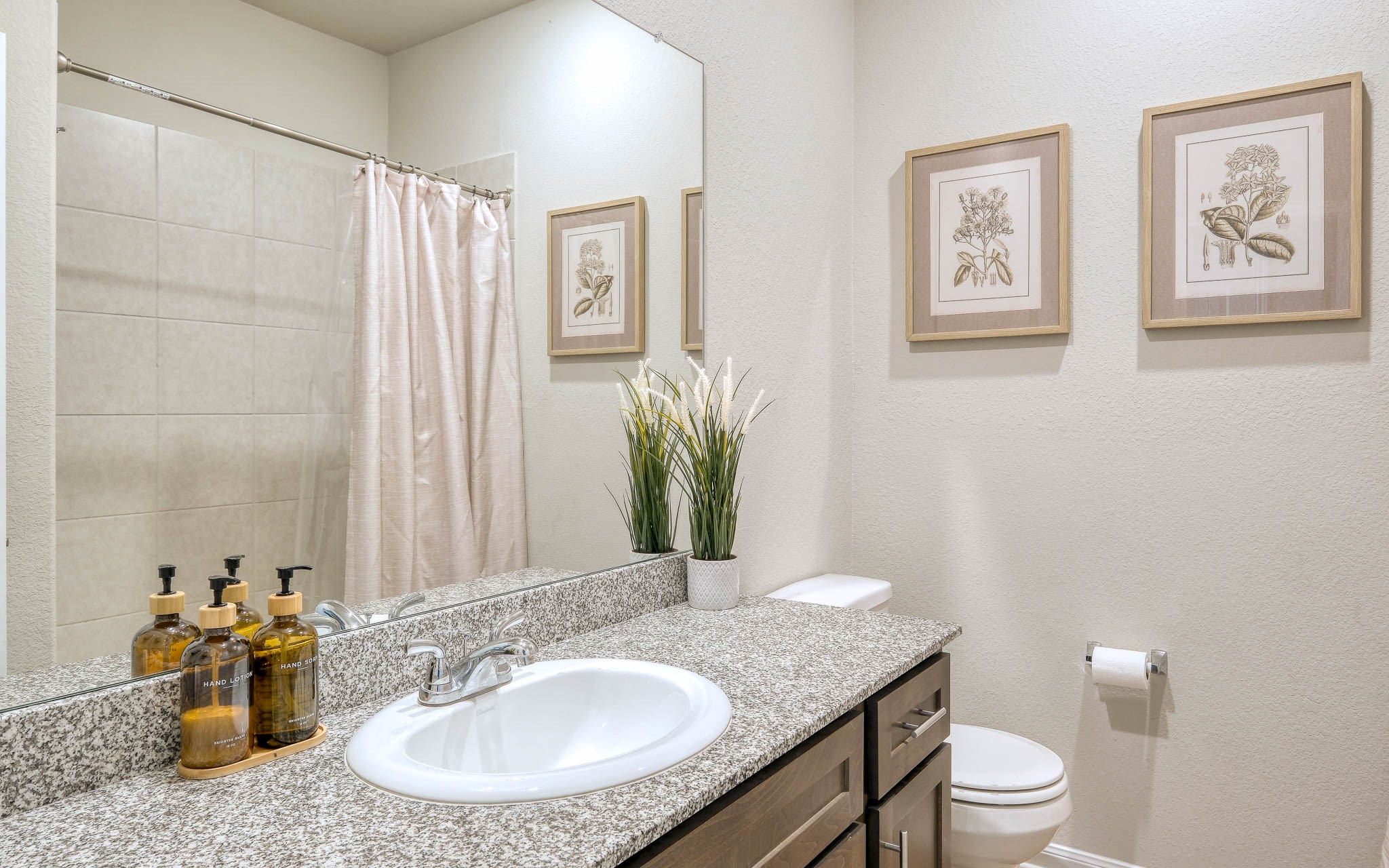 16747 Rockwall Street Conroe, TX 77303 - Photo 34 of 50 a bathroom with a granite countertop sink a toilet and a mirror